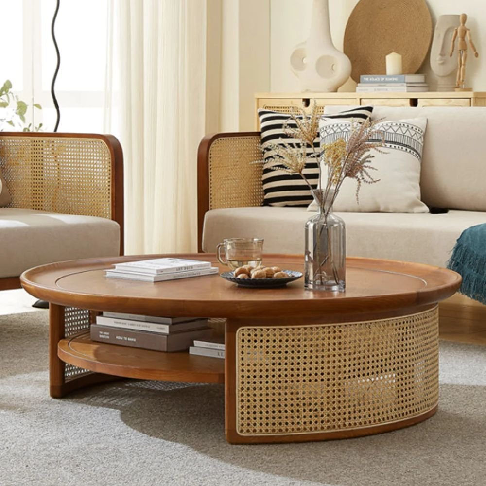 2 A round amber-colored solid wood coffee table with a curved rattan storage shelf - Modera Furnish.
