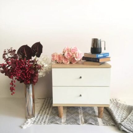 A sophisticated beige and white finish laminated MDF bedside table featuring dual storage drawers and splayed wooden legs - Modera Furnish.