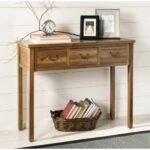 A natural oak color solid wood console table featuring three drawers with antique brass handles and elegant tapered legs - Modera Furnish.