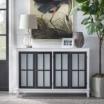 A white 4 door solid wood cabinet featuring black-framed frosted glass panes and tapered legs - Modera Furnish.