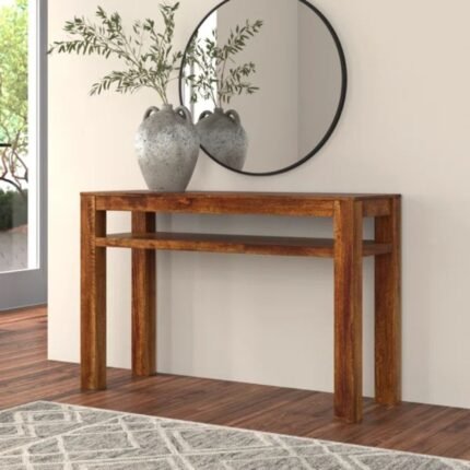 A modern minimalist brown solid wood console table with a thick bridge-style frame in a bright living room - Modera Furnish