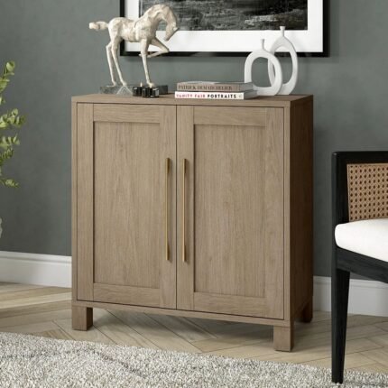 A cool grey 2 door solid wood accent cabinet with long vertical brass handles and square feet - Modera Furnish.