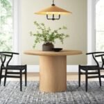 Solid wood round pedestal dining table with matte natural finish in contemporary style - Modera Furnish
