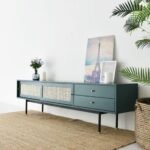 An olive green finish solid acacia wood TV unit featuring two sliding cane doors and two drawers with brass hardware - Modera Furnish.