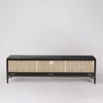 A black solid acacia TV stand featuring a single full-width drop-down cane door revealing three storage compartments - Modera Furnish.
