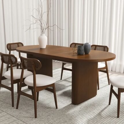 An oval solid wood dining table with ribbed pedestal legs and a natural brown finish - Modera Furnish.
