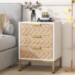A contemporary white solid wood bedside table featuring three drawers with natural wood chevron patterns and a gold metal base - Modera Furnish.