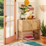 A natural finish solid wood accent cabinet featuring two doors with arched rattan panels and gold hardware - Modera Furnish.