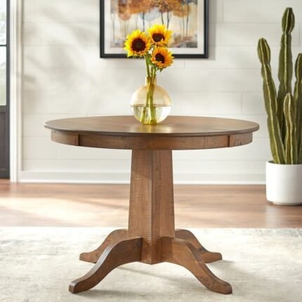 Round solid wood dining table in walnut finish with classic pedestal base – Modera Furnish.