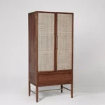 A natural honey solid acacia wardrobe featuring two hand-woven cane doors and a single base storage drawer - Modera Furnish.