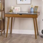 A sophisticated walnut finish solid teak wood study table featuring a seamless integrated drawer, splayed tapered legs, and radiused architectural corners - Modera Furnish.