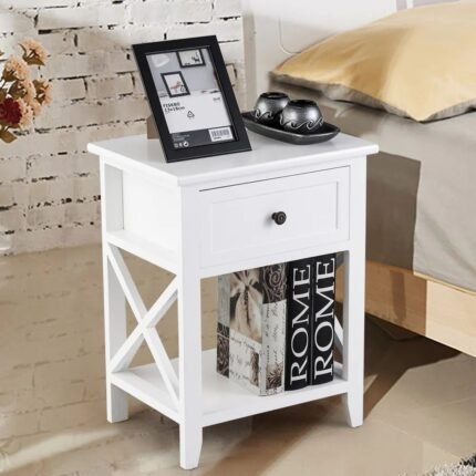 A white solid wood bedside table featuring a single drawer and a unique X-frame side design with an open lower shelf - Modera Furnish.